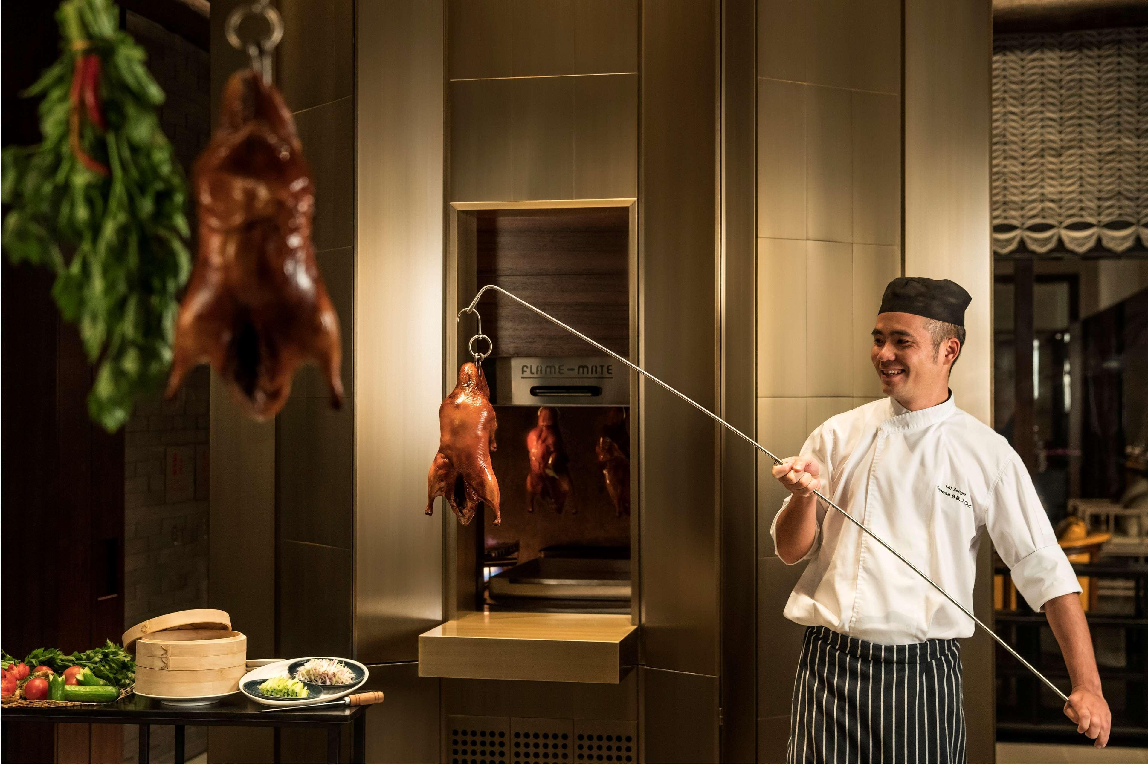 Shangri-La Kolombo Exteriér fotografie Chef pulling a duck out of a hanging oven